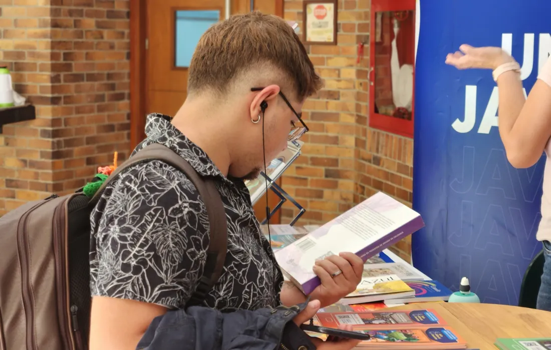 Estudiante leyendo uno de los libros, producto de las investigaciones que aportan a la construcción de paz